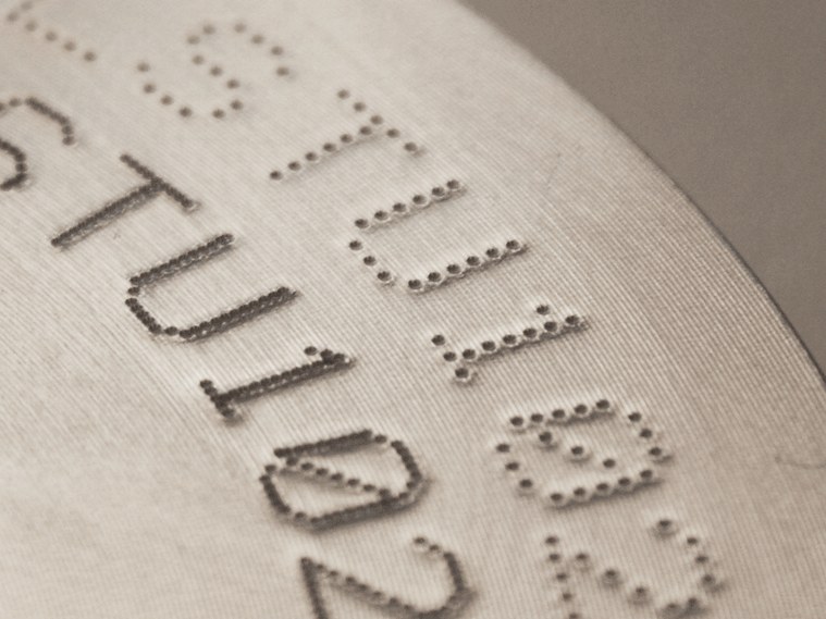 Dot peen text on machined disc